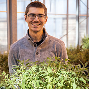 David Koser in campus greenhouse