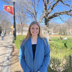 Paige Meyer stands on the East Bank Campus of the U of M with Northrop Mall behind her