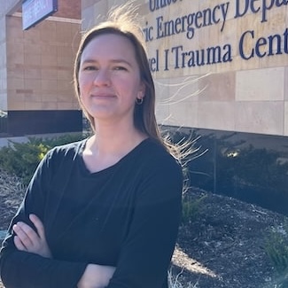 Keely Zimmerman in front of the Level I Trauma Center entrance at Children's Minnesota