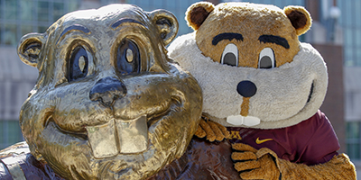 Goldy stands over the shoulder of his namesake bronze statue near Coffman Union on the East Bank of the U of M Campus