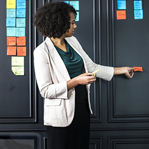 Women pointing at colorful post-it notes