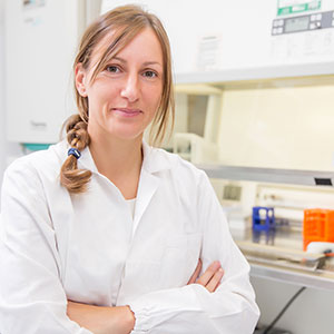 Scientist in white coat in lab