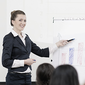  image of a woman presenting a chart to a group