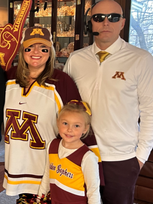 Chris Kispert, his wife, and daughter dress in maroon and gold Gopher gear for Halloween