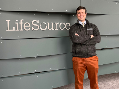 Daniel Samuelson-Roberts stands in front of the LifeSource building he manages