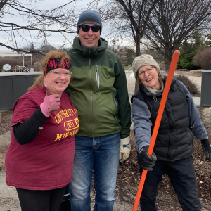 Three people join in the clean up as part of a CCAPS community project for U of M Day of Service