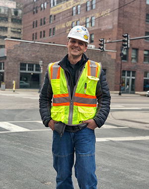 Michael Johnson, with brownstone buildings of the Minneapolis warehouse district in background