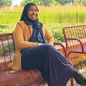 Fardowsa Hassan seated outside St Paul Student Center
