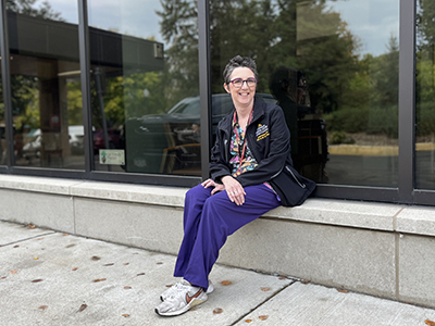 Janet Nelson sits on a window ledge outside the U of M Veterinary Medical Center