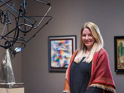 Katie Covey in front of wire sculpture in Weisman Museum
