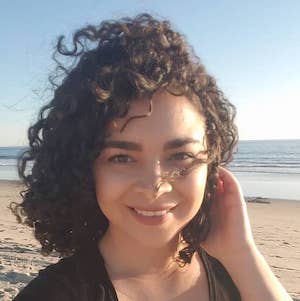 Kiana Hernandez on the beach with the ocean behind her