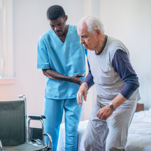 Long term care professional helps a senior resident into a wheelchair