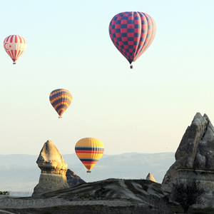 image of hot air balloons flying near rock formations
