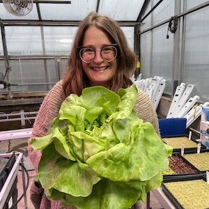 Mary Rogers with a giant head of lettuce