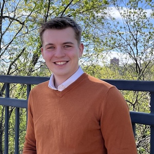 Michael Simeon leans against a railing on East River Road