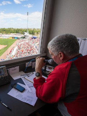 Stew Thornley observes a baseball game from the scorer's box.