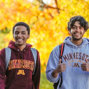 Two U of M students walking across campus