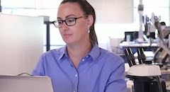 Woman working at computer in office space
