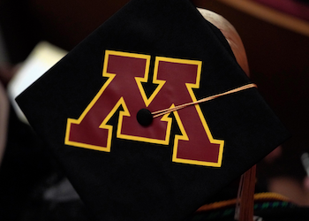 Maroon block M on a graduation cap