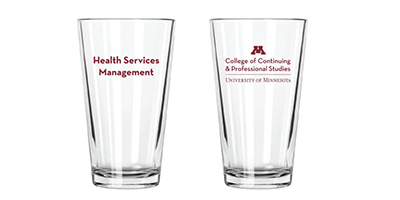 Two clear pint glasses with the CCAPS wordmark on one side and "Health Services Management" on the other