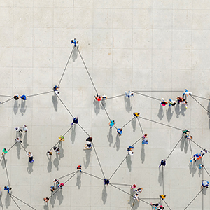 A group of people seen from above with lines drawn connecting them. Networking concept.