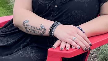 A tattoo on Kendra White's arm says You Are Safe With Me