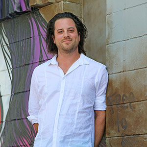 Lucas Erickson in front of Uptown mural