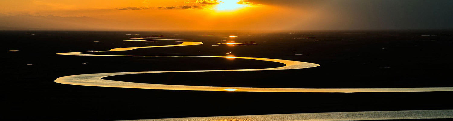  image of a river winding beneath a sunset