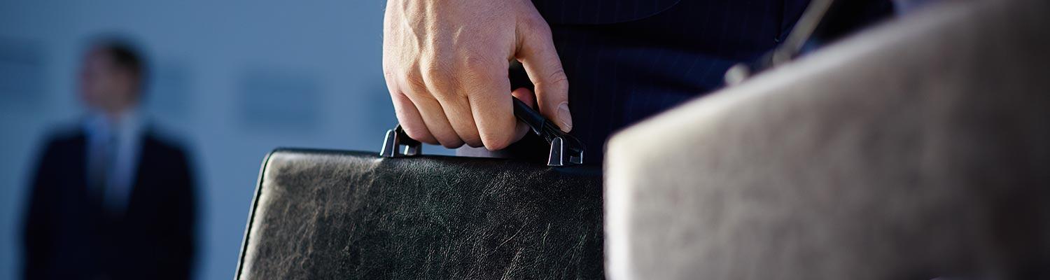  image of a lawyer's briefcase being carried by the handle