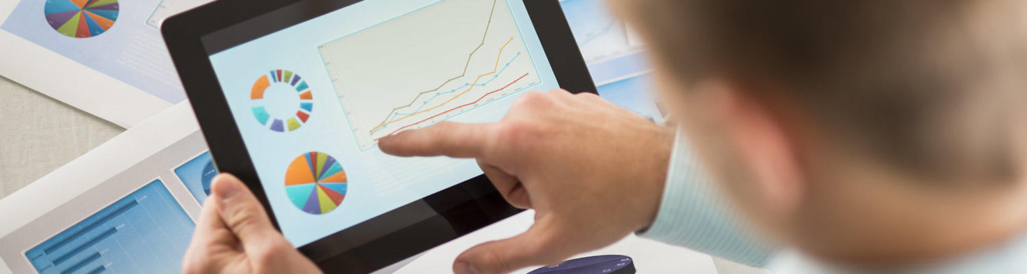 Person pointing to graph on tablet