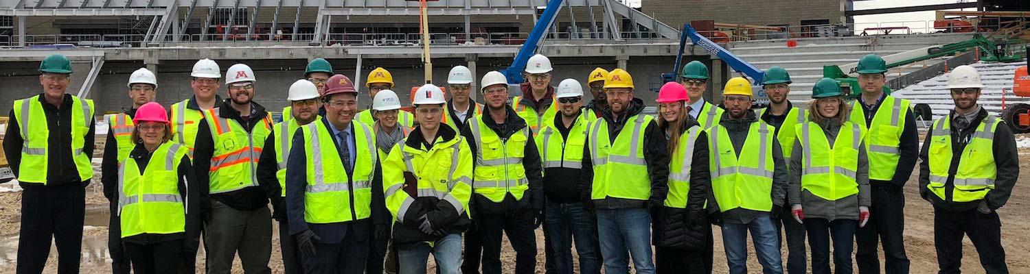 Construction management students and alumni on tour of stadium resized