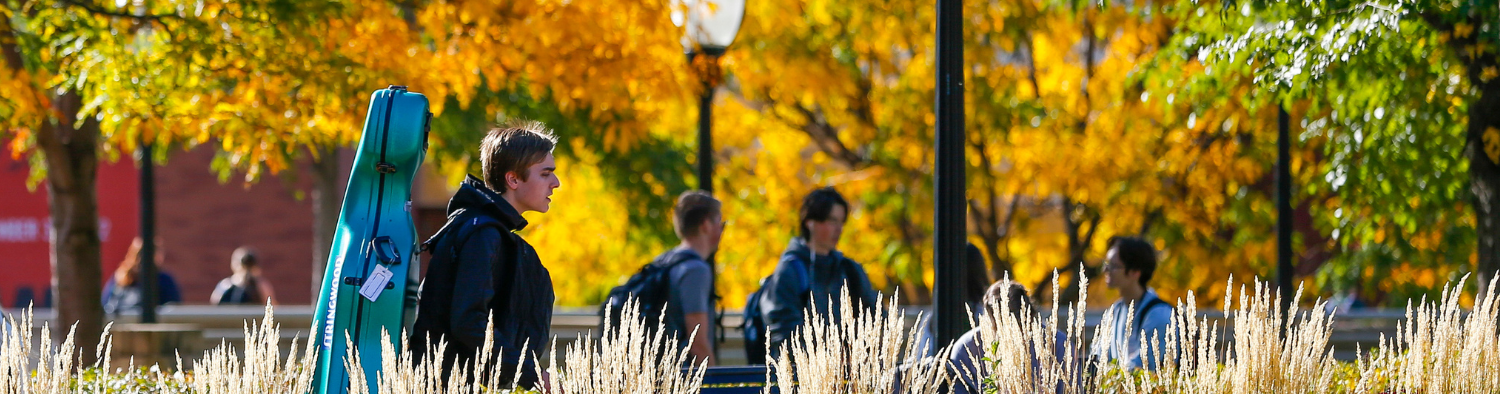 students walk on the East Bank of the UMN Twin Cities on a sunlit autumn day