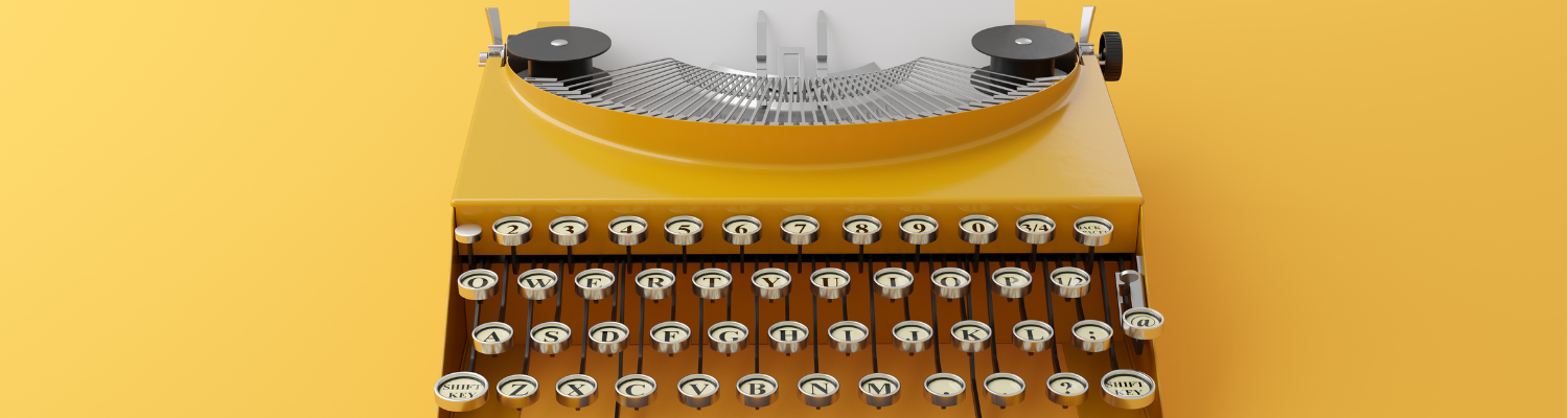 an old golden colored typewriter holds a piece of paper and rests on an equally golden ground