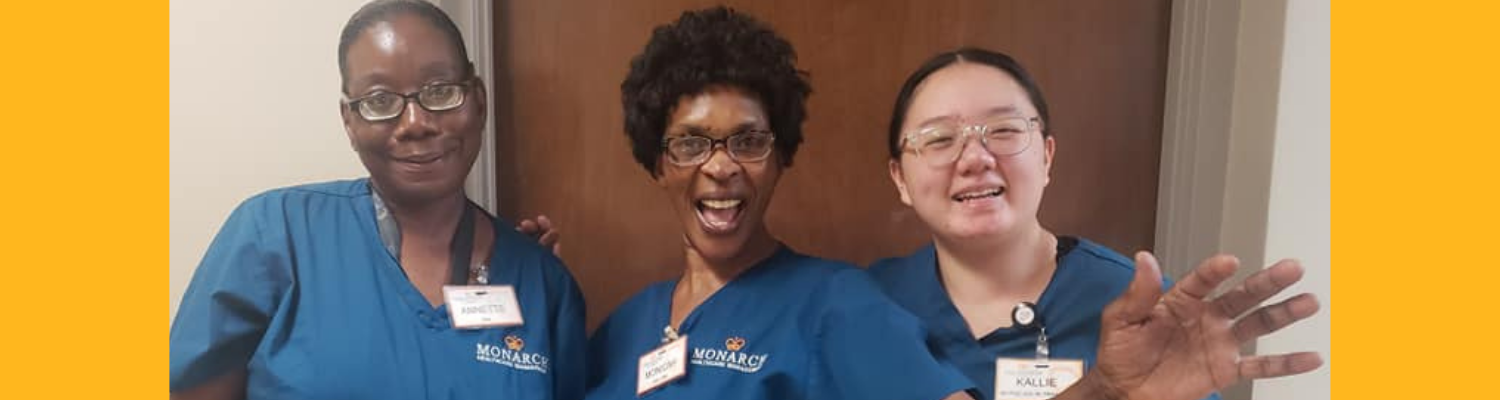 three female Monarch Heathcare workers smile for the camera
