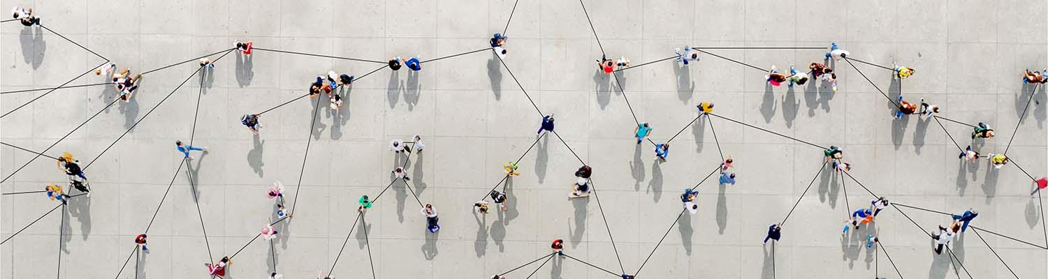 A group of people seen from above with lines drawn connecting them. Networking concept.