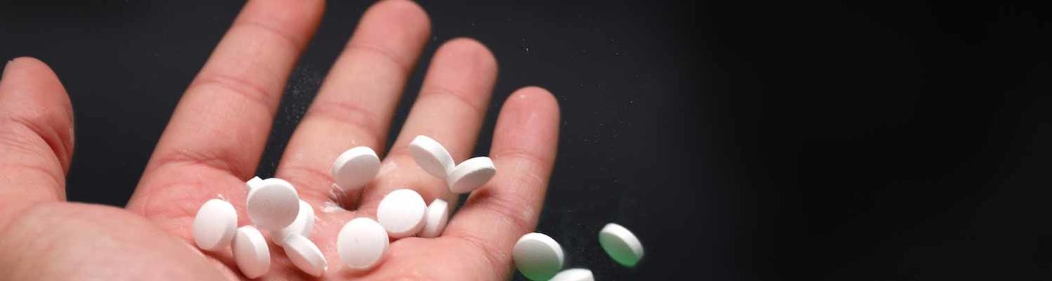 white pills in hand Resized