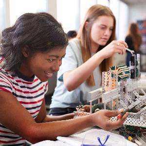 young women work on construction sets in a lab environment