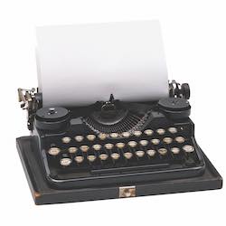 An old black typewriter with a blank sheet of paper in it