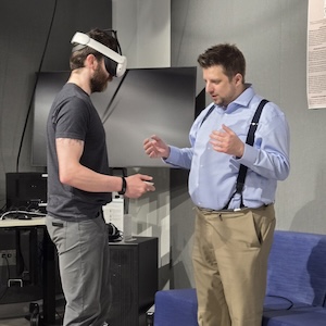 Charlie Heinz works with a student in a VR headset